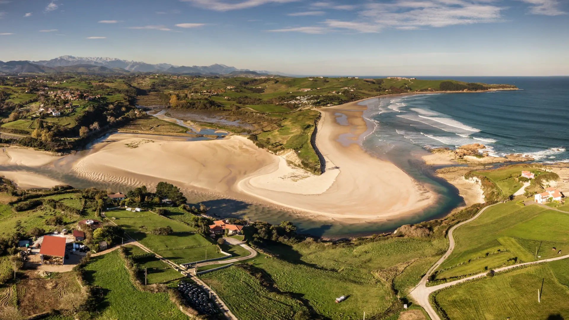 
         La impresionante playa de Cantabria rodeada de montes verdes: dos kilómetros de arena fina, dunas y aguas cristalinas 
    