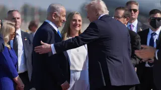President Donald Trump greets Israel's Prime Minister Benjamin Netanyahu as he arrives at Ben Gurion International Airport, Monday, Oct. 13, 2025, near Tel Aviv. (AP Photo/Evan Vucci)