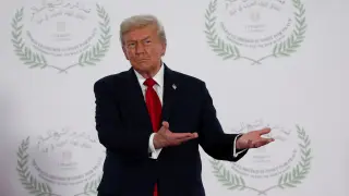 President Donald Trump waits to greet leaders during a summit to support ending the more than two-year Israel-Hamas war in Gaza after a breakthrough ceasefire deal, Monday, Oct. 13, 2025, in Sharm El Sheikh, Egypt. (Suzanne Plunkett/Pool via AP)