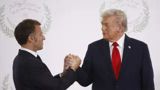 President Donald Trump and French President Emmanuel Macron shake hands during the greetings ceremony before the family picture at the Gaza International Peace Summit, in Sharm el-Sheikh, Egypt, Monday, Oct.13 2025. (Yoan Valat, Pool photo via AP)