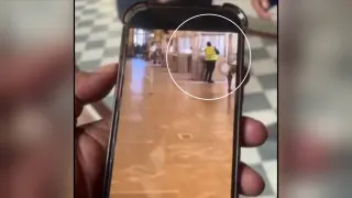 Imagen compartida por la cadena francesa BFMTV que muestra el momento en que uno de los ladrones roba las joyas de una vitrina del Louvre.