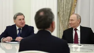 Russian President Vladimir Putin, right, and Russian Presidential foreign policy adviser Yuri Ushakov, left, attend the talks with U.S. special envoy Steve Witkoff, back to a camera, at the Senate Palace of the Kremlin in Moscow, Russia, Tuesday, Dec. 2, 2025. (Alexander Kazakov, Sputnik, Kremlin Pool Photo via AP)