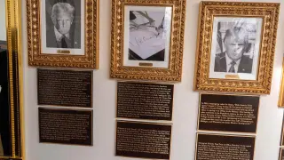 New plaques have been placed underneath presidential portraits on the Colonnade at the White House, Wednesday, Dec. 17, 2025, in Washington. (AP Photo/Alex Brandon)