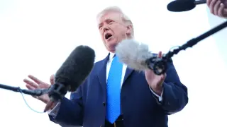 President Donald Trump speaks with the media before boarding Air Force One, Monday, March 23, 2026, at Palm Beach International Airport in West Palm Beach, Fla. (AP Photo/Mark Schiefelbein)