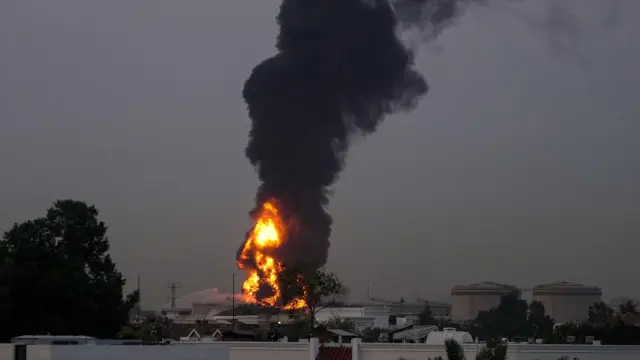 Fire and plumes of smoke rises after a drone struck a fuel tank forcing the temporary suspension of flights. near Dubai International Airport, in United Arab Emirates, early Monday, March 16, 2026. (AP Photo)