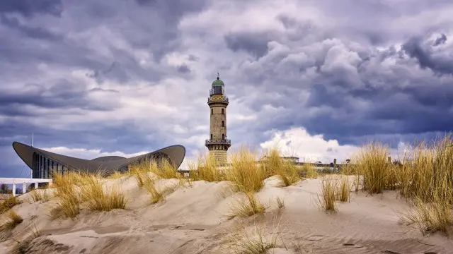 Lighthouse at the Teepott behind the dunes in Warnemünde.
