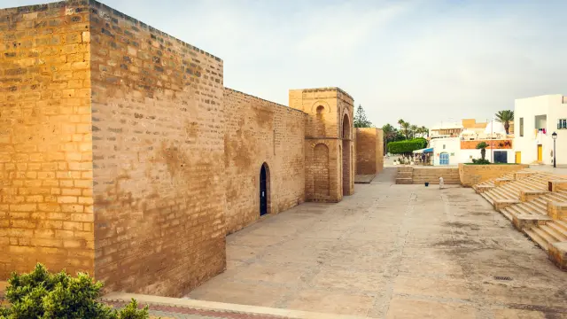 The Great Mosque of Mahdia, Tunisia and Plaza with Steps in the Morning. The Great Mosque of Mahdiya is a mosque that was built in the tenth century in Mahdia, Tunisia. Located on the southern side of the peninsula on which the old city was located, the mosque was built in 916 CE (303-304 in the Islamic calendar), after the founding of the city within the walls built by the Caliphate on an artificial platform "reclaimed from the sea" as mentioned by the Andalusian geographer Al-Bakri.[1] The other buildings erected nearby at that time have since disappeared.