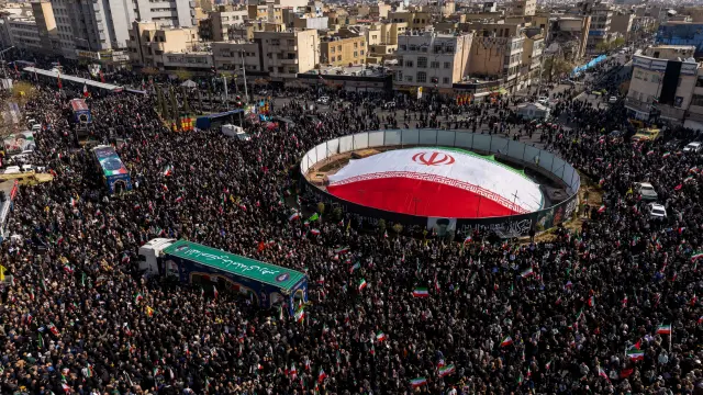 TEHRAN, IRAN - MARCH 18: Large crowds gather during a joint funeral held for Ali Larijani, Secretary of Iran's Supreme National Security Council, Basij commander Major General Gholam Soleimani, and 84 sailors from the Iranian Navy frigate IRIS Dena, on March 18, 2026 in Tehran, Iran. Larijani and Gholamreza, two of the highest-ranking Iranian officials to be assassinated since the outbreak of the war on February 28, were killed in US-Israeli airstrikes on March 17, according to Iranian state media. The 84 sailors were killed when the IRIS Dena was sunk in a torpedo strike by the USSCharlotte, an American submarine,off the coast of Sri Lanka on March 4. (Photo by Majid Saeedi/Getty Images)