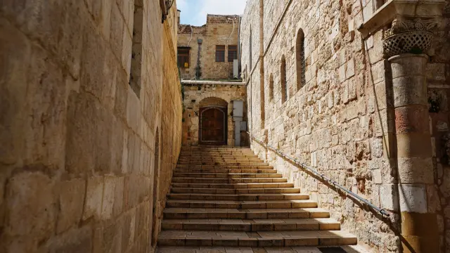 Una puerta y unas escaleras vacías conducen a la Iglesia del Santo Sepulcro en la Ciudad Vieja de Jerusalén, cerrada a los visitantes por la guerra con Irán.