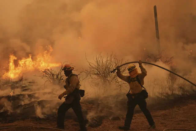 Firefighter battle the Canyon Fire on Thursday, Aug. 7, 2025, in Hasley Canyon, Calif. (AP Photo/Marcio Jose Sanchez)