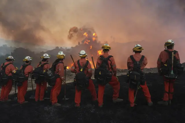 A California Department of Corrections fire crew watches as the Canyon Fire burns on Thursday, Aug. 7, 2025, in Hasley Canyon, Calif. (AP Photo/Marcio Jose Sanchez)