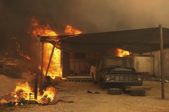 The Canyon Fire burns a structure on Thursday, Aug. 7, 2025, in Halsey Canyon, Calif. (AP Photo/Marcio Jose Sanchez)
