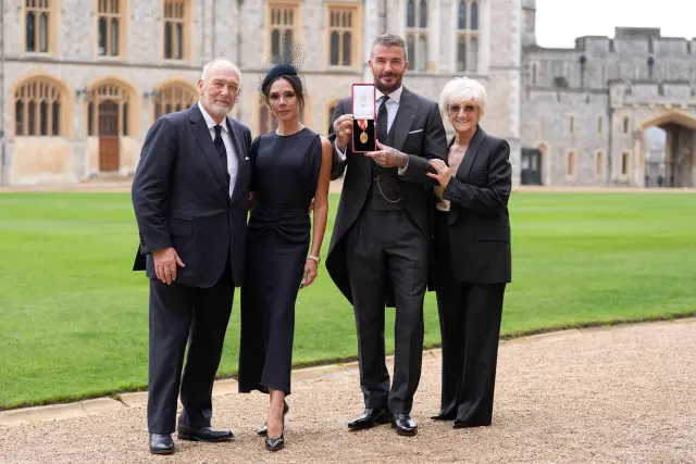 Sir David Beckham, with his wife Lady Victoria and parents Ted and Sandra Beckham, after he was made a Knight Bachelor at an investiture ceremony at Windsor Castle, Berkshire, England, Tuesday, Nov. 4, 2025. (Andrew Matthews/Pool Photo via AP)