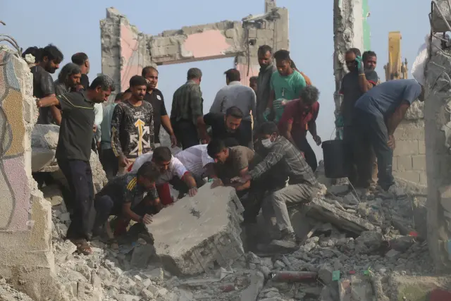 Rescue workers and residents search through the rubble in the aftermath of what Iranian officials said was an Israeli-U.S. strike on a girls' elementary school in Minab, Iran, Saturday, Feb. 28, 2026. (Abbas Zakeri/Mehr News Agency via AP)