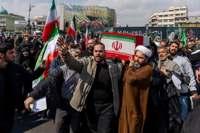 TEHRAN, IRAN - MARCH 18: People carry a casket during a joint funeral held for Ali Larijani, Secretary of Iran's Supreme National Security Council, Basij commander Major General Gholam Soleimani, and 84 sailors from the Iranian Navy frigate IRIS Dena, on March 18, 2026 in Tehran, Iran. Larijani and Gholamreza, two of the highest-ranking Iranian officials to be assassinated since the outbreak of the war on February 28, were killed in US-Israeli airstrikes on March 17, according to Iranian state media. The 84 sailors were killed when the IRIS Dena was sunk in a torpedo strike by the USSCharlotte, an American submarine,off the coast of Sri Lanka on March 4. (Photo by Majid Saeedi/Getty Images)