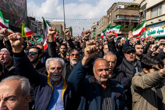 TEHRAN, IRAN - MARCH 18: Members of the crowd gesture during a joint funeral held for Ali Larijani, Secretary of Iran's Supreme National Security Council, Basij commander Major General Gholam Soleimani, and 84 sailors from the Iranian Navy frigate IRIS Dena, on March 18, 2026 in Tehran, Iran. Larijani and Gholamreza, two of the highest-ranking Iranian officials to be assassinated since the outbreak of the war on February 28, were killed in US-Israeli airstrikes on March 17, according to Iranian state media. The 84 sailors were killed when the IRIS Dena was sunk in a torpedo strike by the USSCharlotte, an American submarine,off the coast of Sri Lanka on March 4. (Photo by Majid Saeedi/Getty Images)