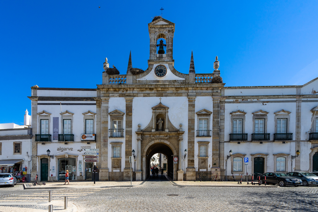 View of the Arco da Vila (Town Archway), one of he medieval gateways to Faro old town. Faro, Algarve, Portugal, April 2019