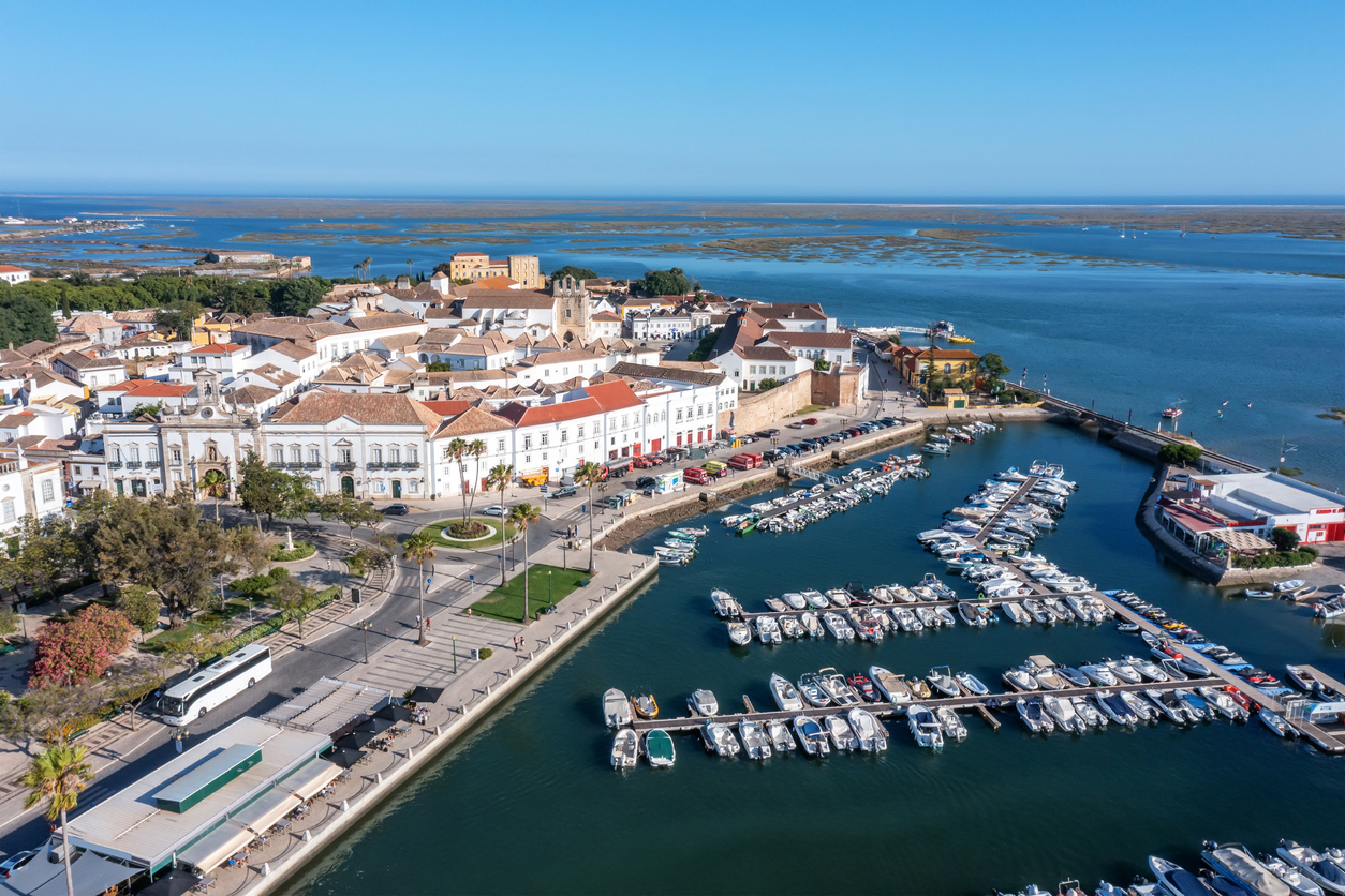 Aerial view of the city of Faro in Portugal with a view of the seaside tourist port and the old town in the background.