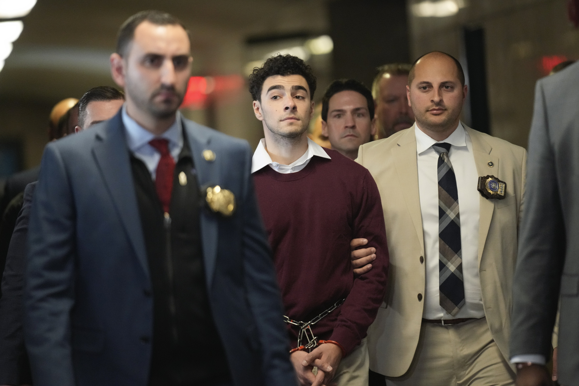 Luigi Mangione is escorted into Manhattan Criminal court for his arraignment on state murder and terror charges in the killing of UnitedHealthcare CEO Brian Thompson, Monday, Dec. 23, 2024, in New York. (AP Photo/Seth Wenig)