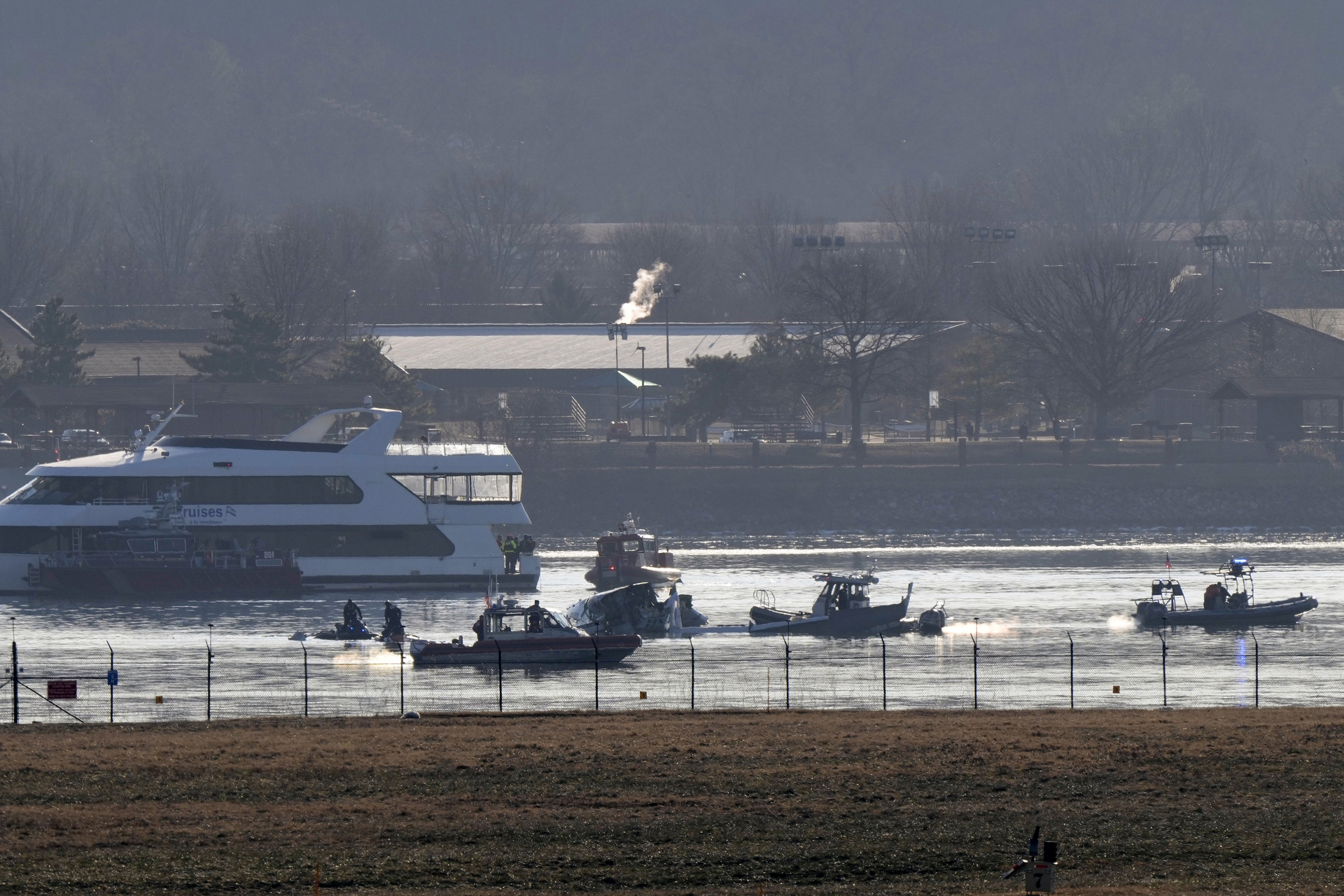 Search and rescue efforts are seen around a wreckage site in the Potomac River from Ronald Reagan Washington National Airport, early Thursday morning, Jan. 30, 2025, in Arlington, Va. (AP Photo/Mark Schiefelbein)
