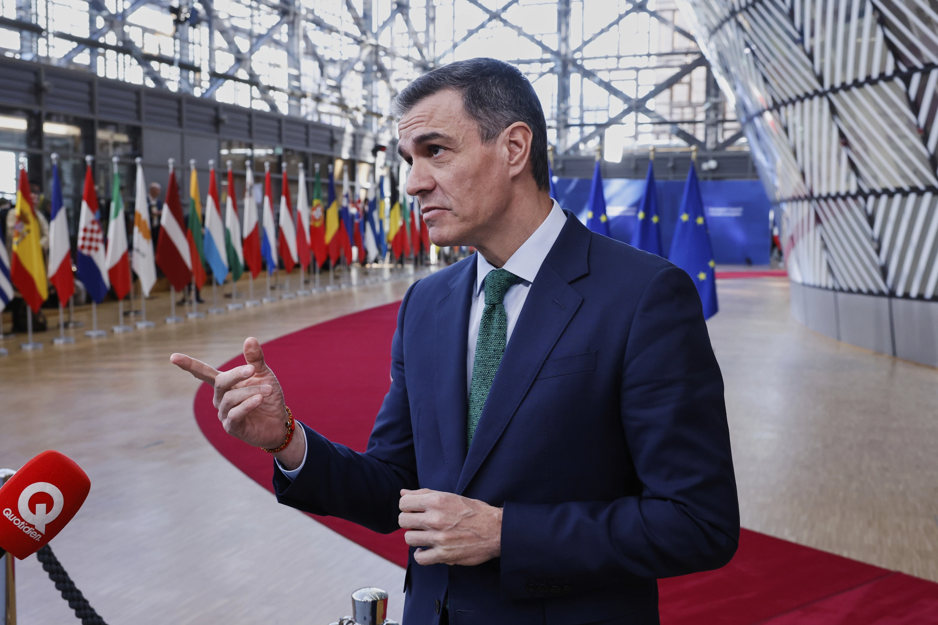 Spain's Prime Minister Pedro Sanchez speaks with the media as he arrives for an EU Summit at the European Council building in Brussels, Thursday, March 6, 2025. (AP Photo/Omar Havana)