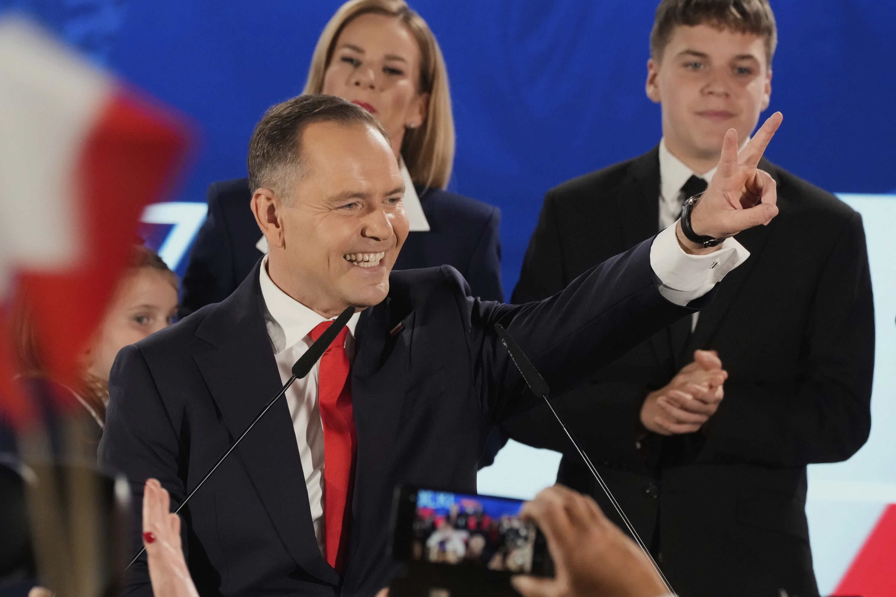 Presidential candidate Karol Nawrocki, a conservative historian backed by the right-wing Law and Justice party greets supporters as he arrives at his headquarters after the presidential election runoff in Warsaw, Poland, Sunday, June 1, 2025. (AP Photo/Czarek Sokolowski)