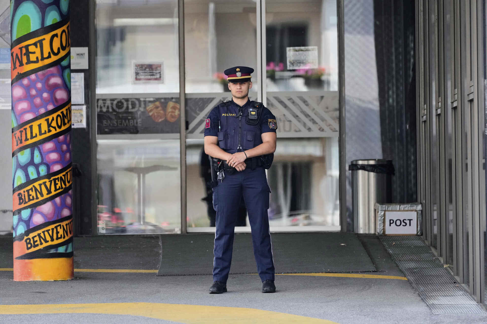 A police officer guars the entrance of a school where a former student opened fire the day before fatally wounding 10 people and injuring many others before taking his own life, Graz, Austria, Wednesday, June 11, 2025. (AP Photo/Darko Bandic) Associated Press / LaPresse Only italy and spain