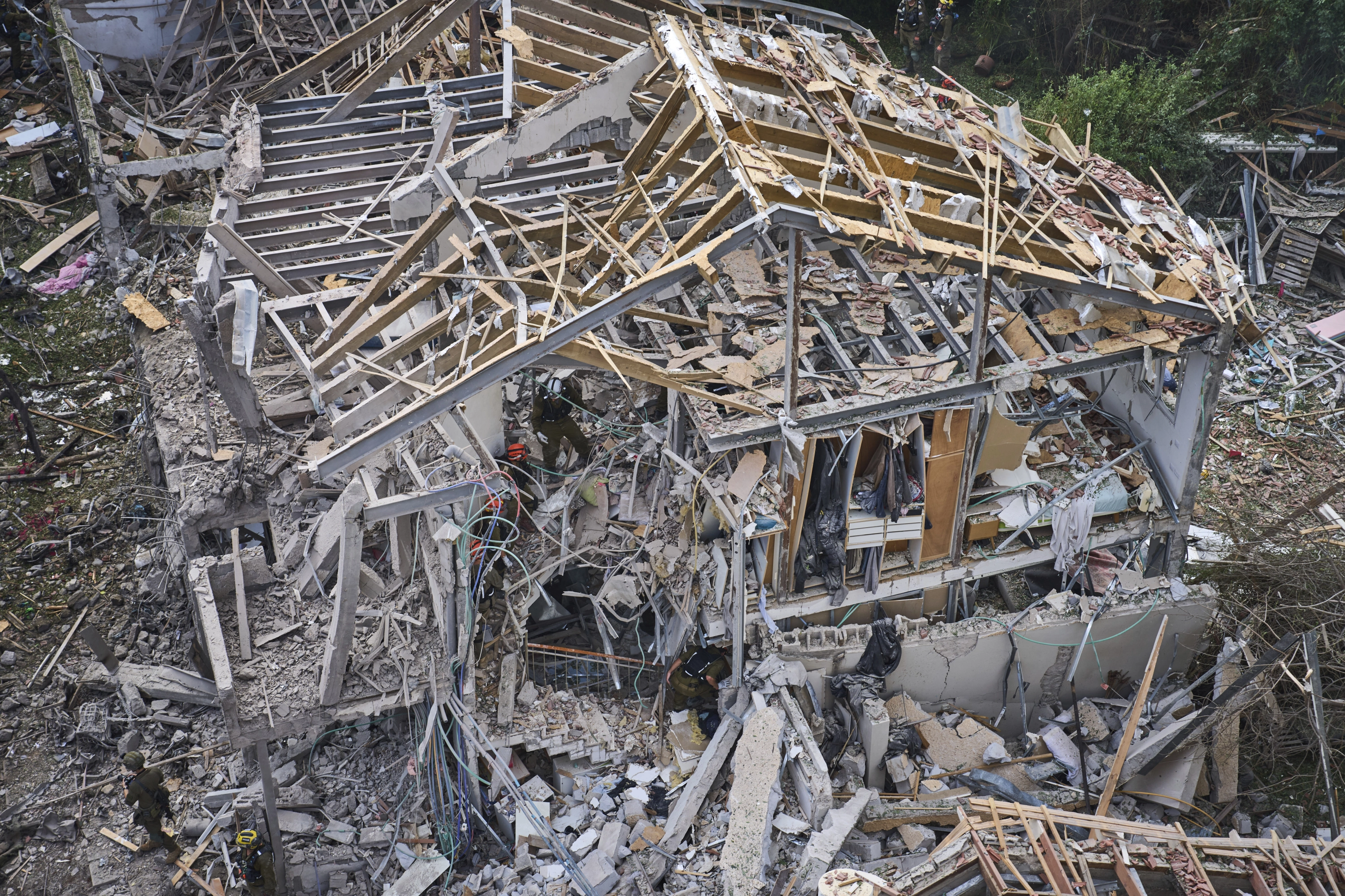 Rescatistas y fuerzas de seguridad trabajan en el lugar de un ataque con misiles lanzado desde Irán en Tel Aviv, Israel, este domingo.