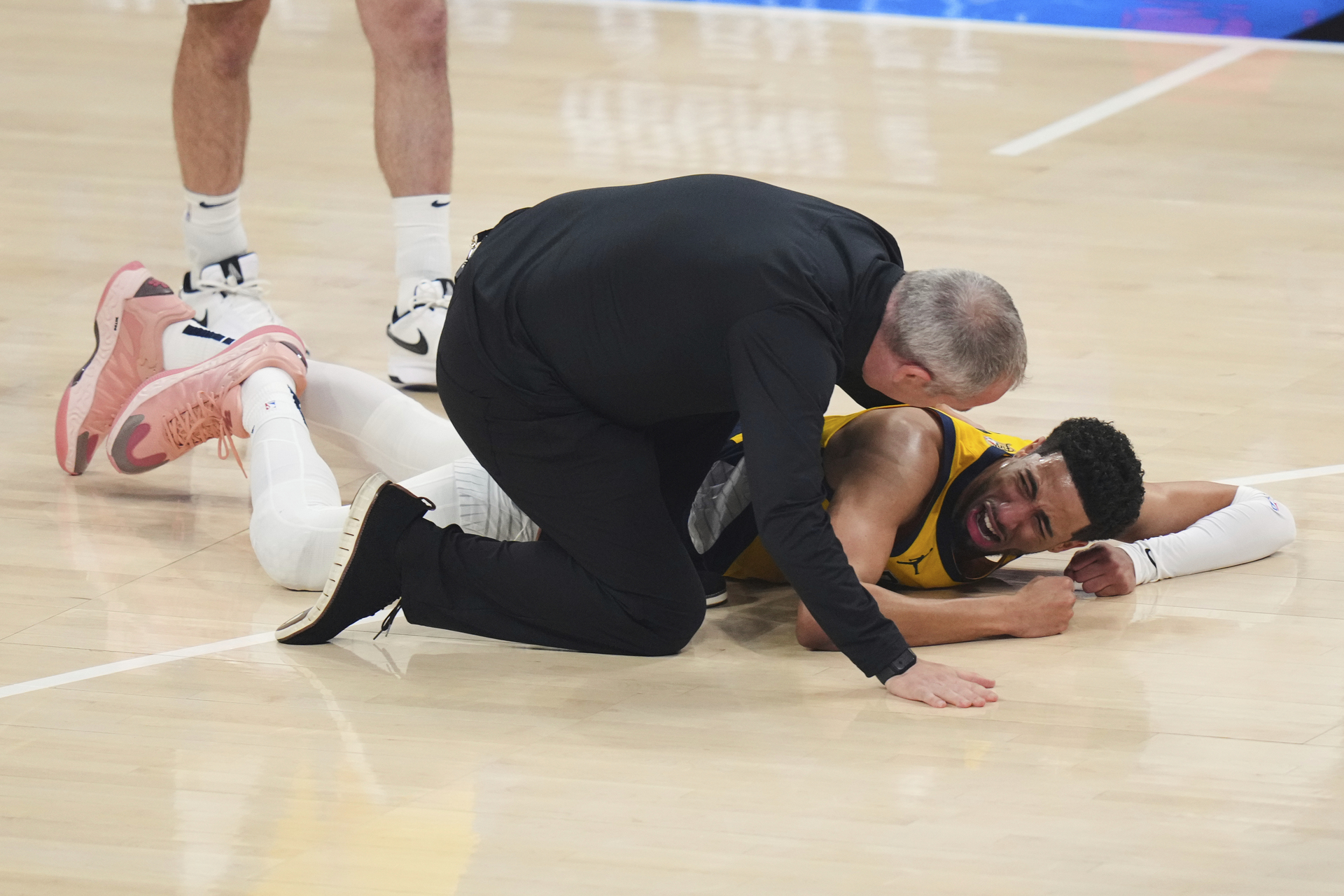 Indiana Pacers guard Tyrese Haliburton lays on the court after an injury during the first half of Game 7 of the NBA Finals basketball series against the Oklahoma City Thunder Sunday, June 22, 2025, in Oklahoma City. (AP Photo/Nate Billings)