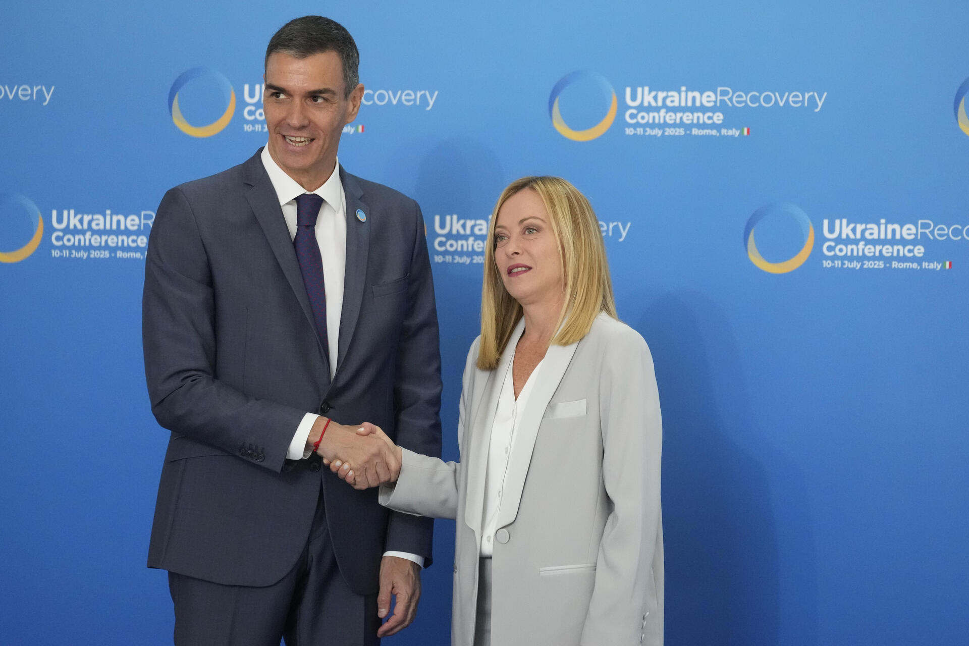 Spanish Prime Minister Pedro Sanchez is welcomed by Italian Prime Minister Giorgia Meloni during the Ukraine Recovery Conference at La Nuvola convention center in Rome, Thursday, July 10, 2025. (AP Photo/Gregorio Borgia)